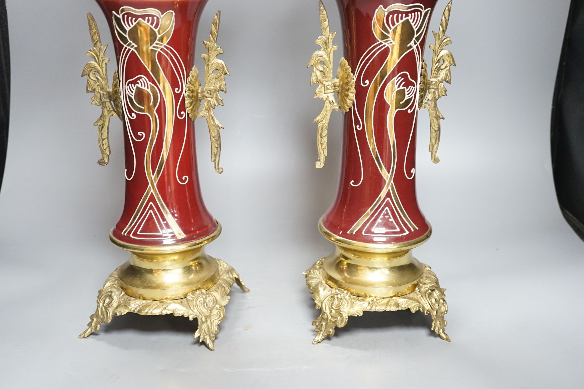 A pair of large brass and ceramic mounted candelabra, 64.5 cms high.
